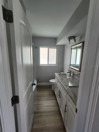 a bathroom with 2 sink and mirror