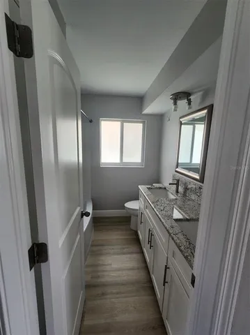 a bathroom with 2 sink and mirror