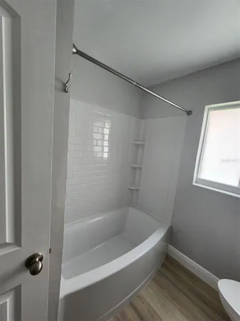 a white bath tub sitting next to a window