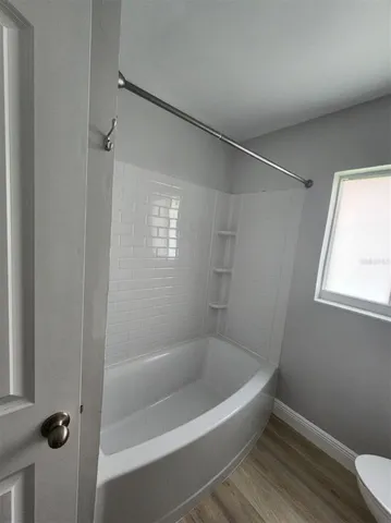 a white bath tub sitting next to a window