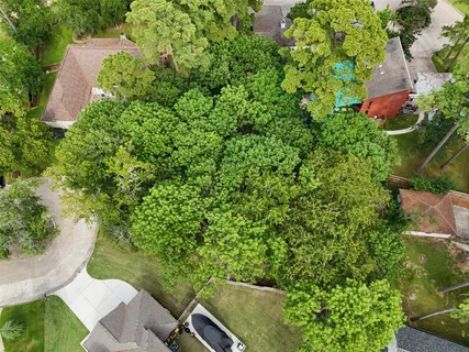 an aerial view of a house with garden space and street view