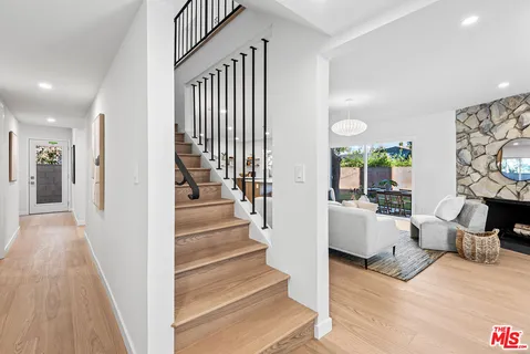a view of entryway and hall with wooden floor