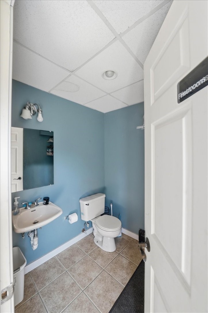 32 Equestrian Way Cranston, RI 02921 - Photo 35 of 50 A separately accessed restroom (public) serves the first-floor common area, adding valuable convenience for gatherings, hobbies and time spent around the garage and equestrian facilities.