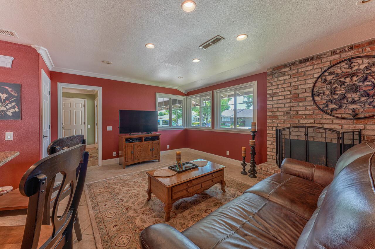 1239 Ayer Drive Gilroy, CA 95020 - Photo 12 of 39 a living room with furniture a flat screen tv and a large window