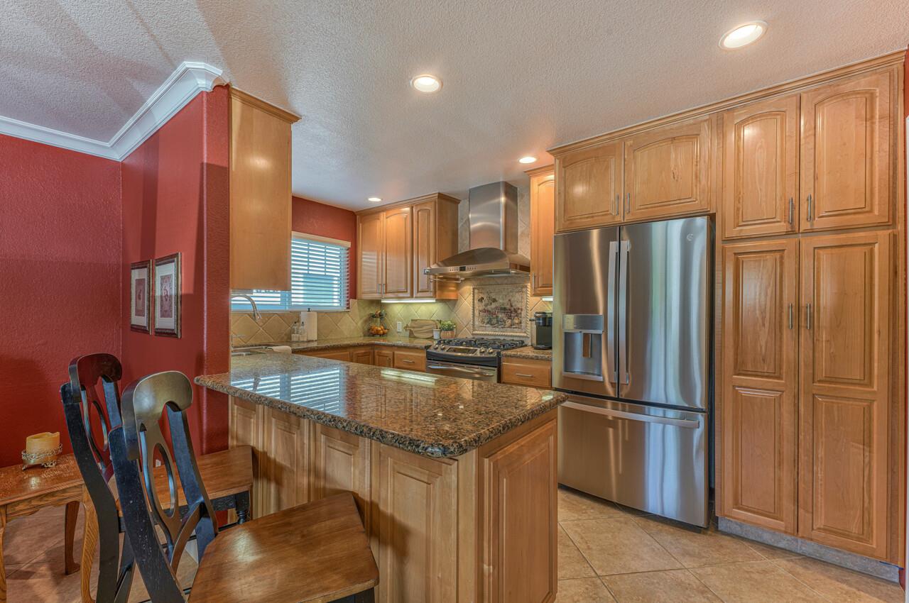 1239 Ayer Drive Gilroy, CA 95020 - Photo 14 of 39 a kitchen with stainless steel appliances granite countertop a refrigerator a stove and a sink