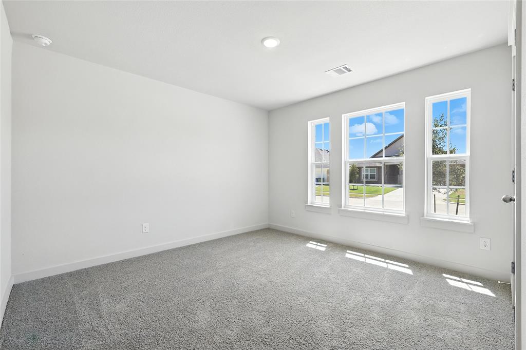 1795 Gleasondale Place Forney, TX 75126 - Photo 22 of 29 Empty room with carpet floors and a smoke detector