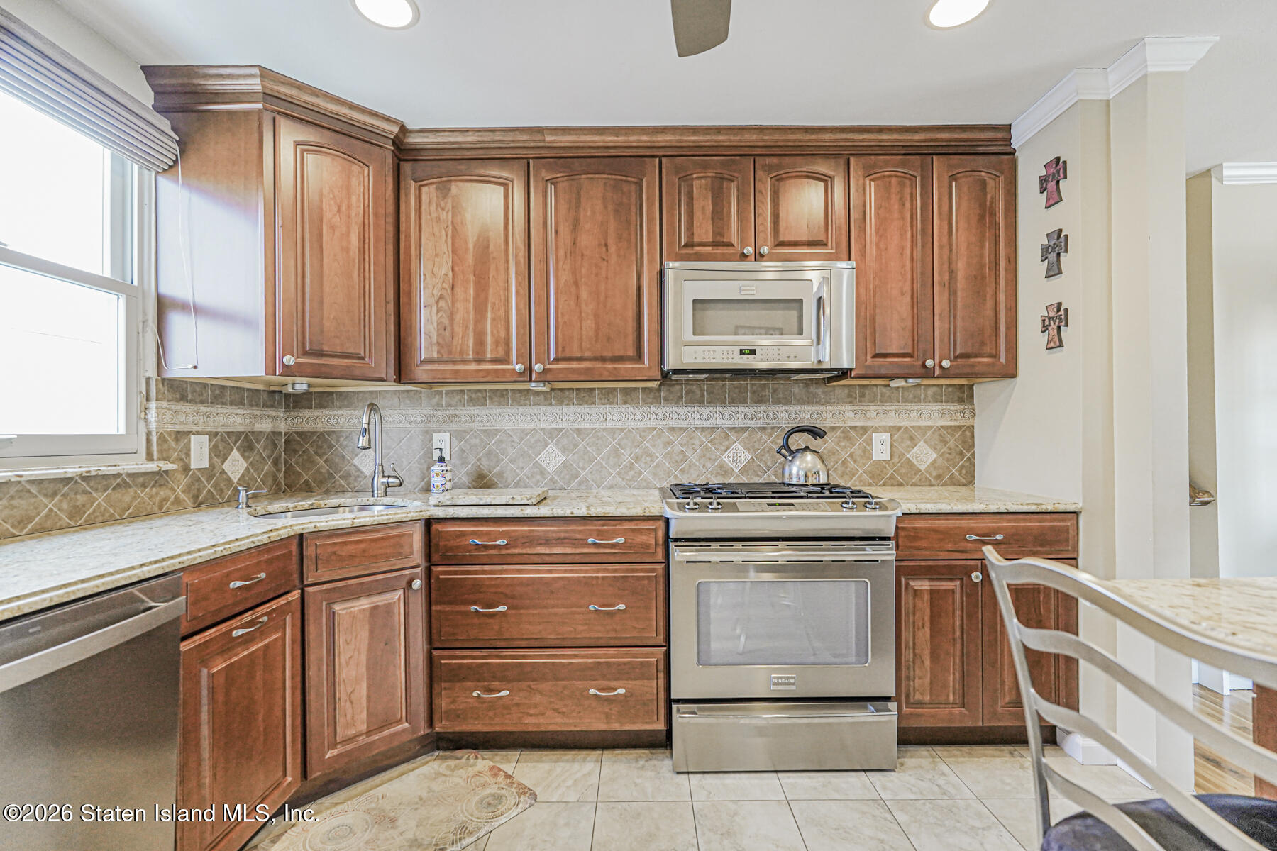 76 Berry Avenue Staten Island, NY 10312 - Photo 12 of 42 a kitchen with stainless steel appliances granite countertop a stove a sink and a microwave