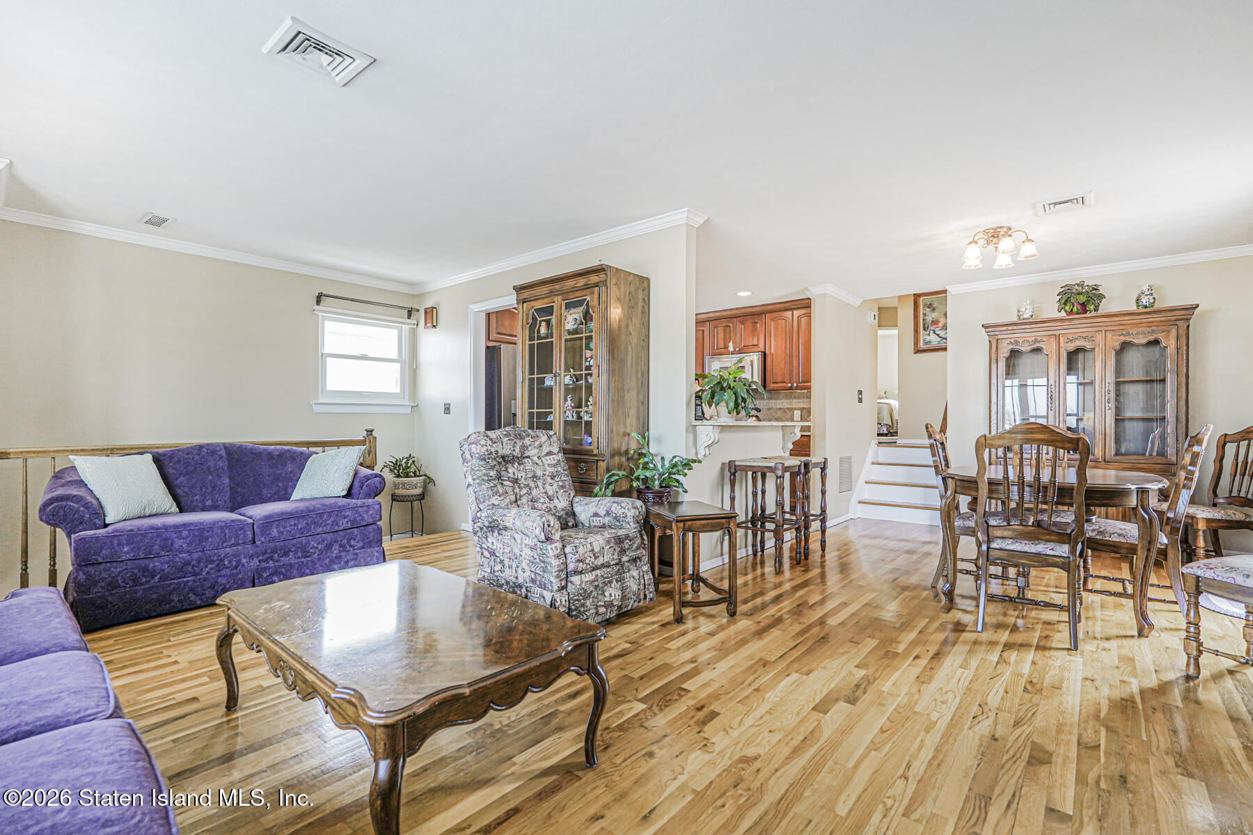 76 Berry Avenue Staten Island, NY 10312 - Photo 13 of 42 a living room with furniture a wooden floor and next to a window
