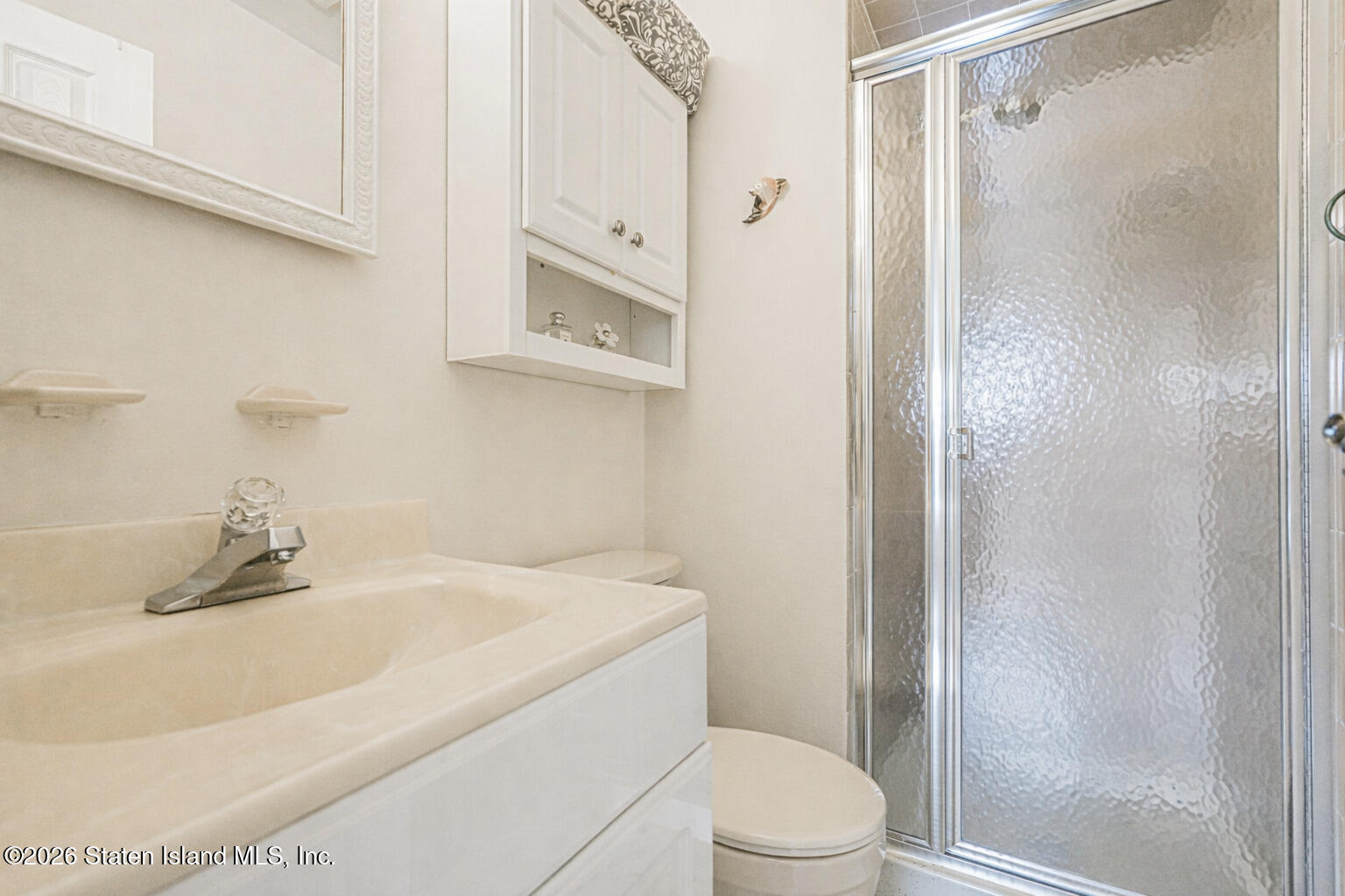 76 Berry Avenue Staten Island, NY 10312 - Photo 20 of 42 a bathroom with a sink toilet and shower