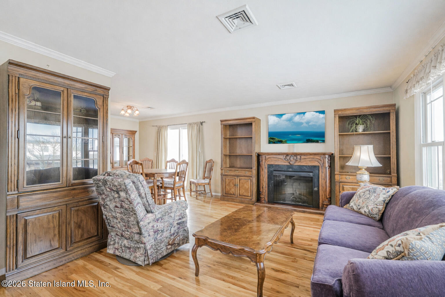 76 Berry Avenue Staten Island, NY 10312 - Photo 4 of 42 a living room with furniture and a fireplace