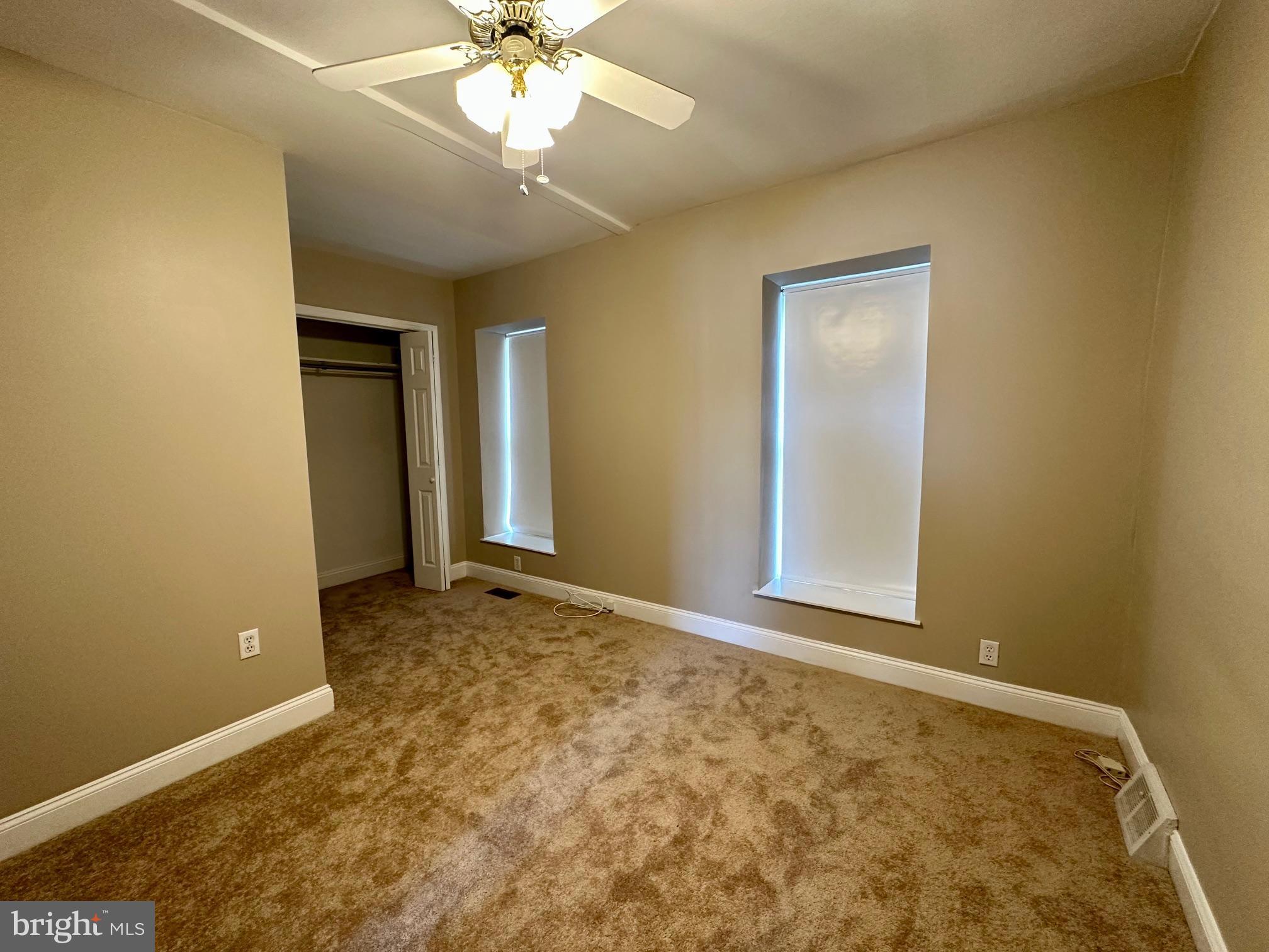 3922 Manor Street Philadelphia, PA 19128 - Photo 12 of 30 an empty room with a chandelier fan and windows