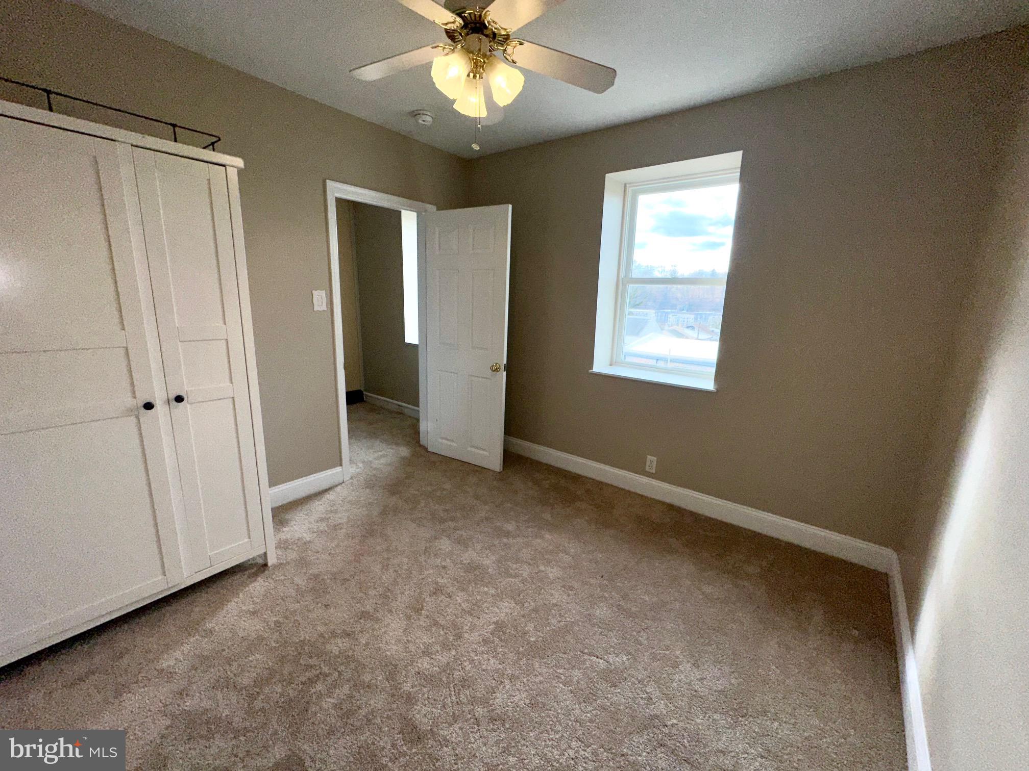 3922 Manor Street Philadelphia, PA 19128 - Photo 18 of 30 an empty room with windows and fan