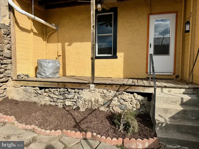 a front view of a house with wooden fence