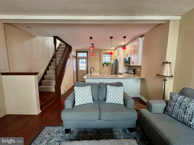 a living room with furniture and a chandelier