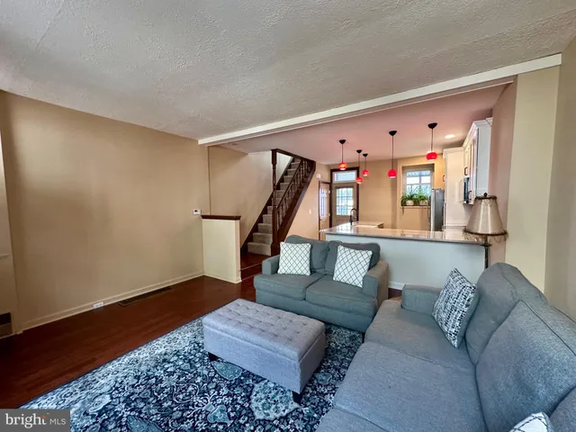 a living room with furniture and stairs