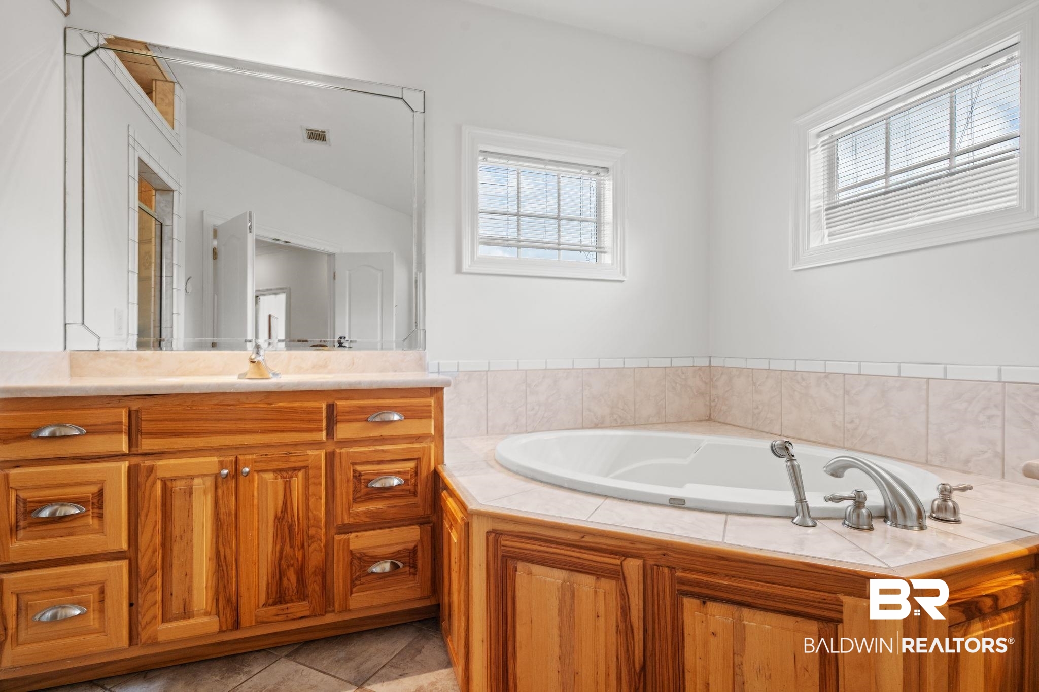 29634 St George Street Daphne, AL 36526 - Photo 32 of 47 Bathroom featuring vanity, a garden tub, and light tile patterned floors