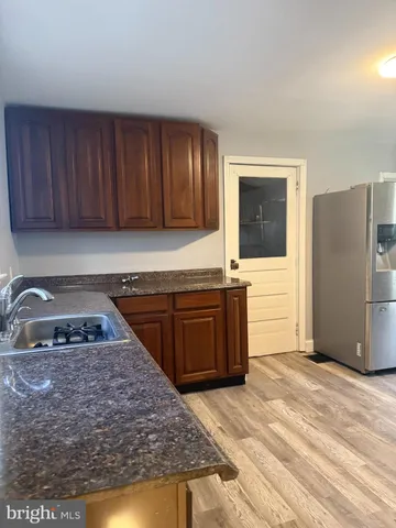 a kitchen with a refrigerator and a sink