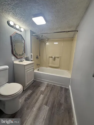 a bathroom with a toilet a sink and a mirror