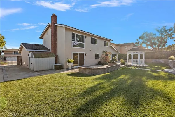 aerial view of a house with a backyard