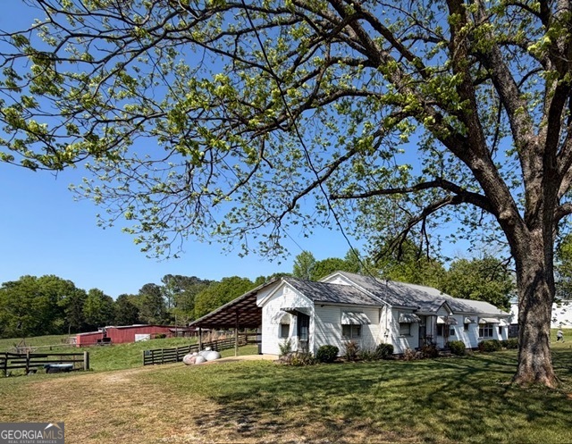 32737 Highway 48 Graham, AL 36263 - Photo 3 of 69 a front view of a house with a yard and large tree
