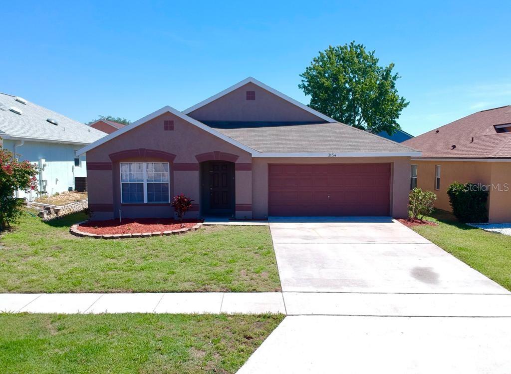 3154 Rawcliffe Road Clermont, FL 34714 - Photo 1 of 1 a front view of a house with a garden and yard