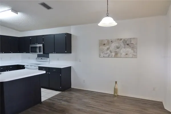a kitchen with stainless steel appliances granite countertop a sink stove and microwave