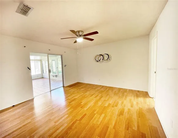 a view of an empty room and wooden floor