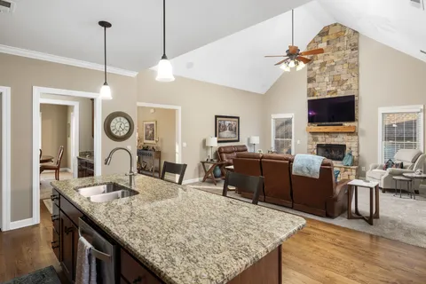a living room with fireplace furniture and a flat screen tv