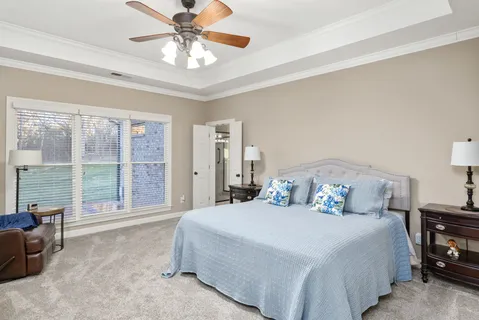 a bedroom with a large bed and a large window