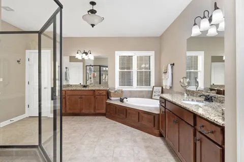 a large bathroom with a double vanity sink mirror and double