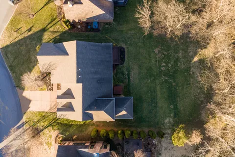 an aerial view of a house with a yard basket ball court and outdoor seating