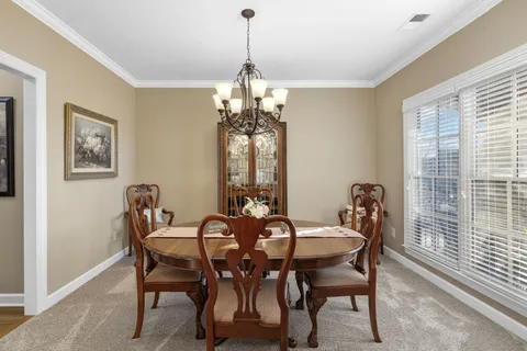 a view of a dining room with furniture and window