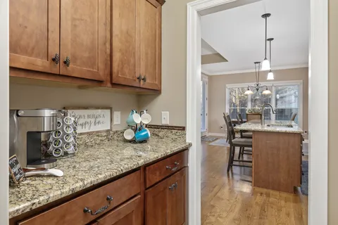 a kitchen with granite countertop stainless steel appliances sink and cabinets