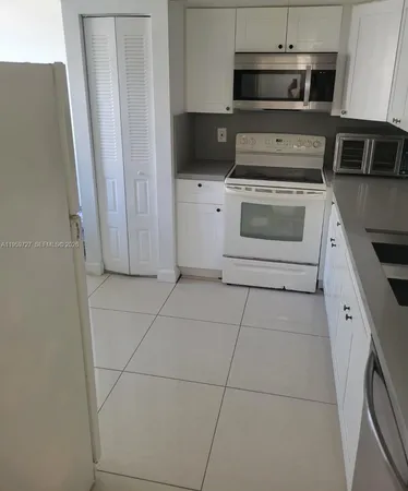 a kitchen with a stove microwave and sink