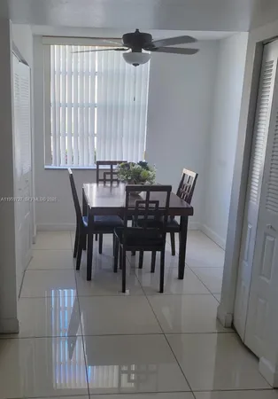 a view of a dining room with furniture and window