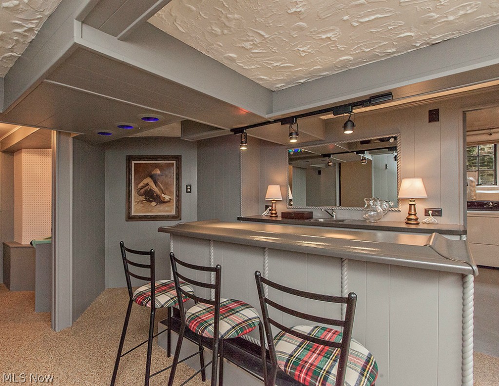 2650 Coventry Road Cleveland, OH 44120 - Photo 21 of 25 The lower level bar has nature stone flooring and is a fun spot for entertaining.