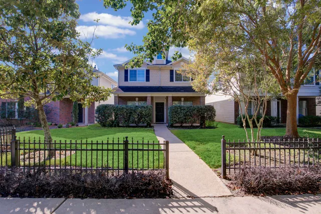 a front view of a house with a garden and plants