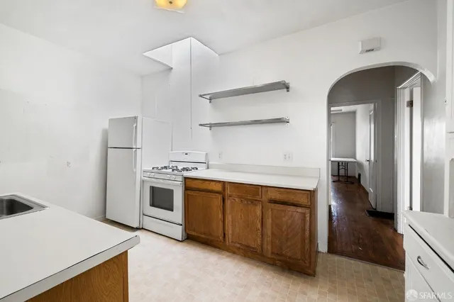 a kitchen with a stove and a refrigerator