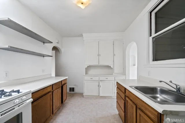 a kitchen that has a sink and a stove