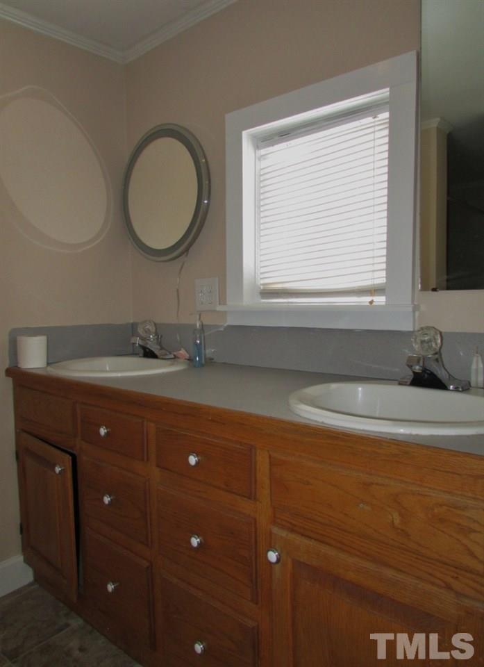414 McGhees Mill Road Roxboro, NC 27574 - Photo 11 of 22 a bathroom with a sink and a mirror