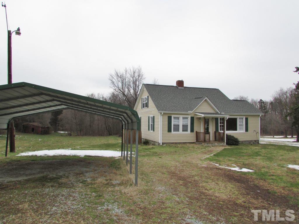 414 McGhees Mill Road Roxboro, NC 27574 - Photo 22 of 22 a view of a yard in front of a house with a large tree
