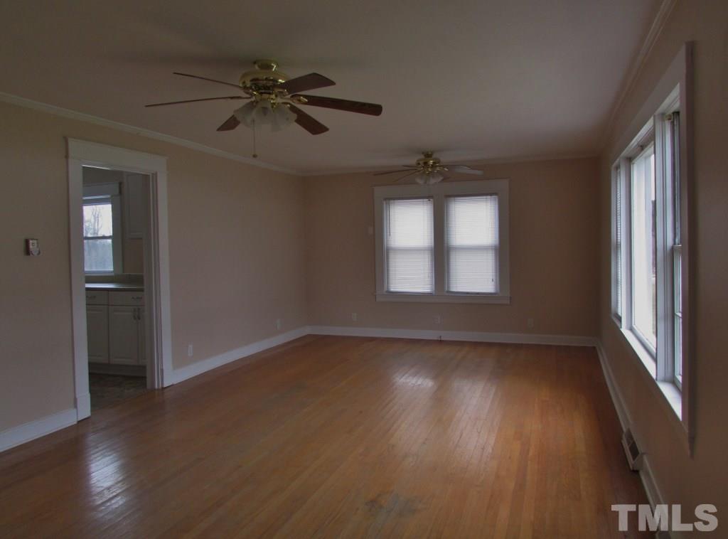 414 McGhees Mill Road Roxboro, NC 27574 - Photo 4 of 22 a view of an empty room with wooden floor and a window