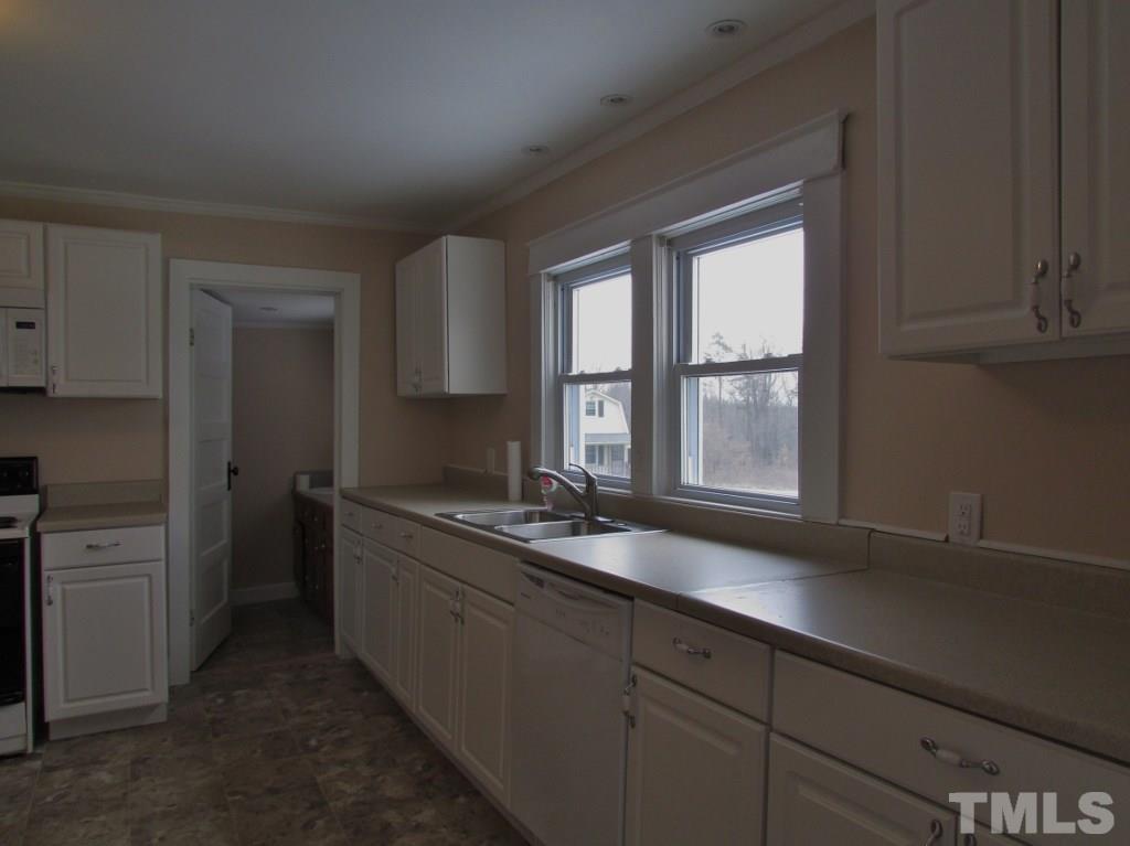 414 McGhees Mill Road Roxboro, NC 27574 - Photo 6 of 22 a kitchen with a sink and large window