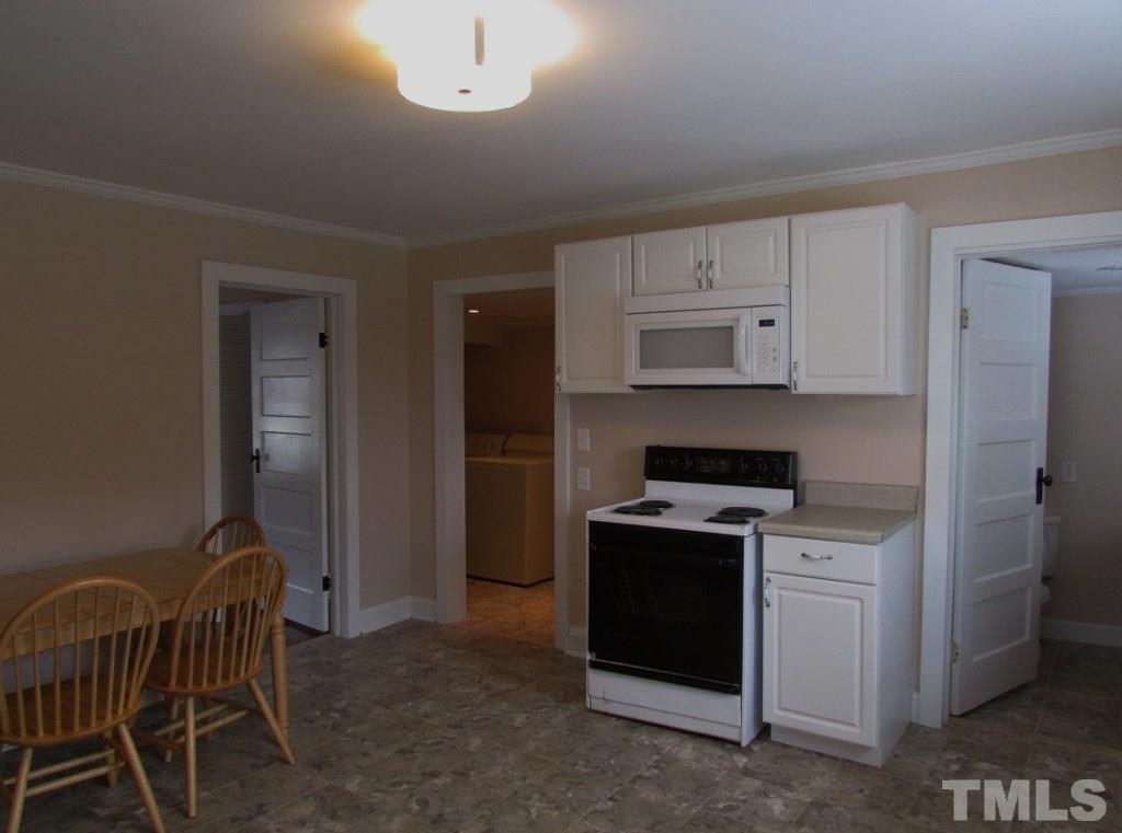 414 McGhees Mill Road Roxboro, NC 27574 - Photo 7 of 22 a kitchen with a stove a sink and a refrigerator