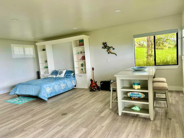 a bedroom with a bed and a chair