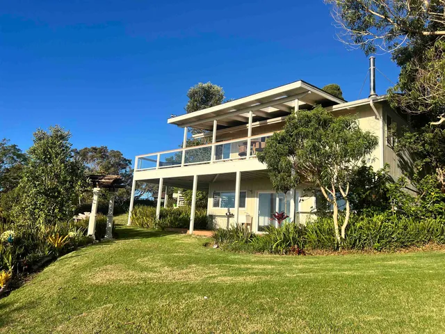 a front view of a house with a garden