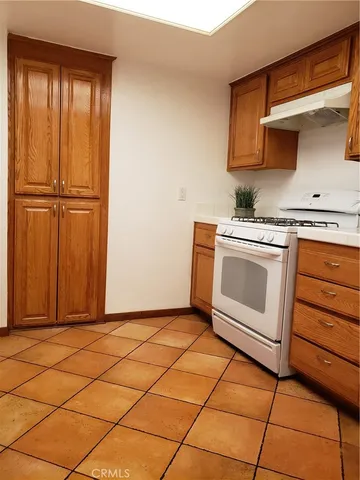 a kitchen with a stove top oven and cabinets