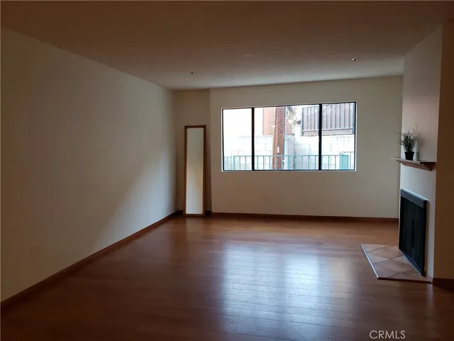 a view of wooden floor and windows in an empty room