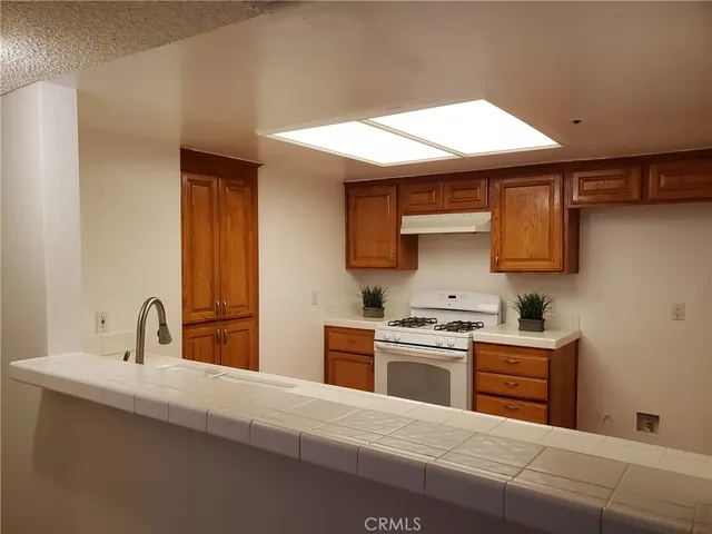 a kitchen with stainless steel appliances a sink stove and cabinets