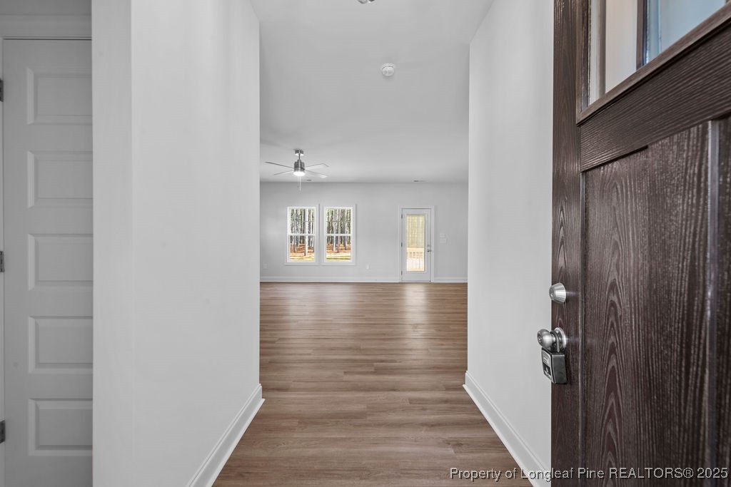 1004 Rhum Drive Fayetteville, NC 28311 - Photo 4 of 34 a view of a hallway with wooden floor and a bathroom